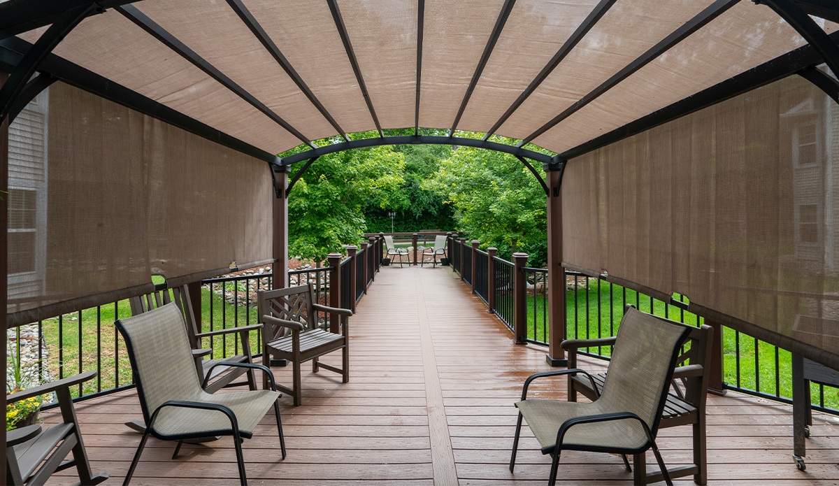 shaded patio area with comfortable chairs and tables