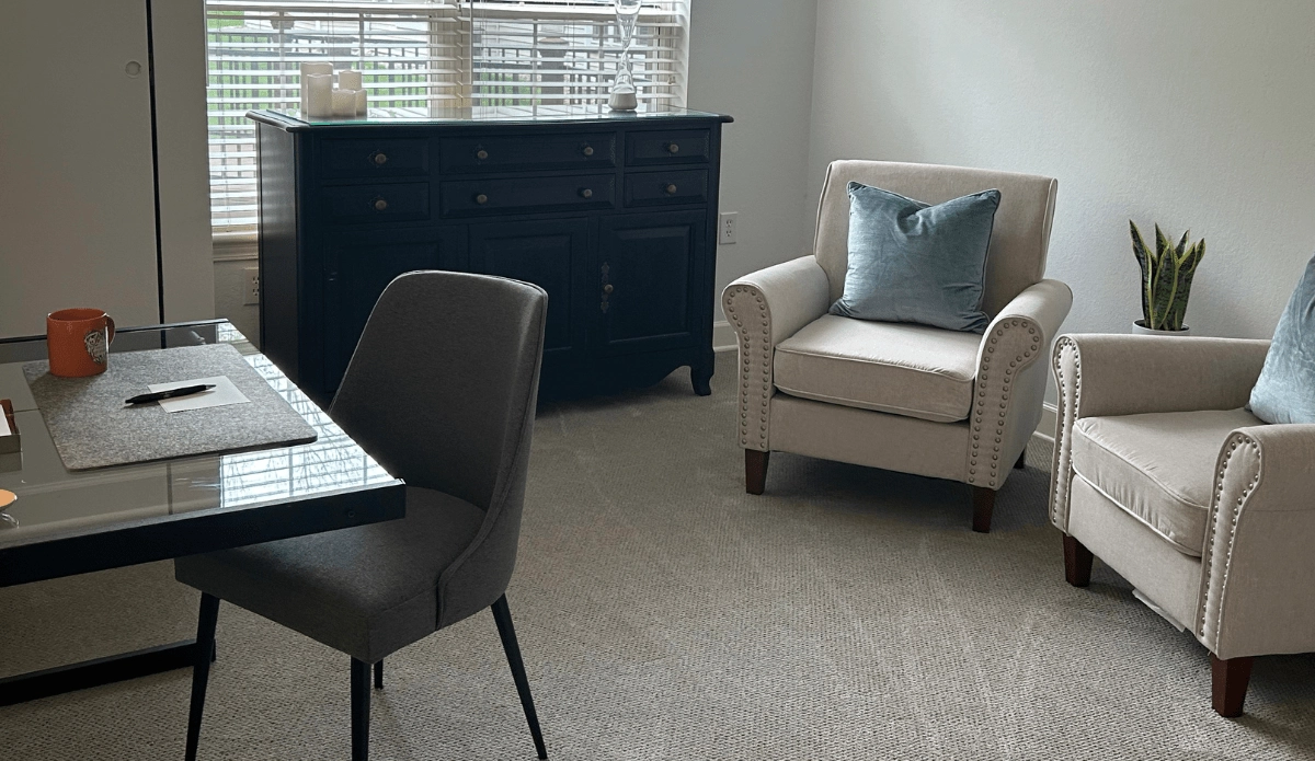 home office featuring a desk and two chairs, perfect for work or study.