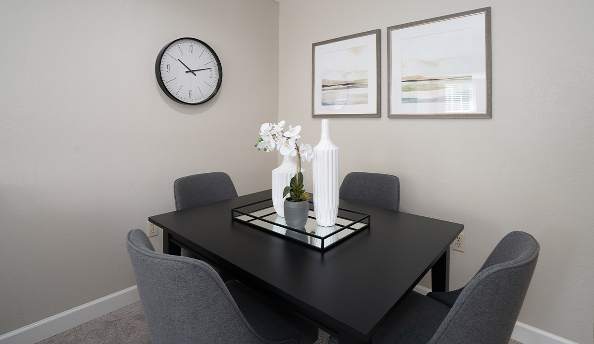 Dining room featuring a clock and a vase on the table